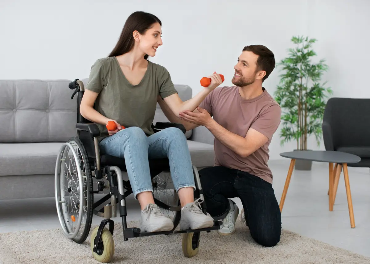 A man and woman in a wheelchair holding tomatoes.