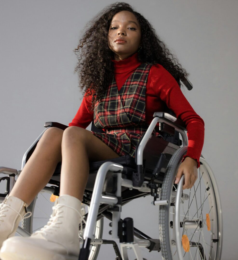 A woman in a wheelchair with white boots.